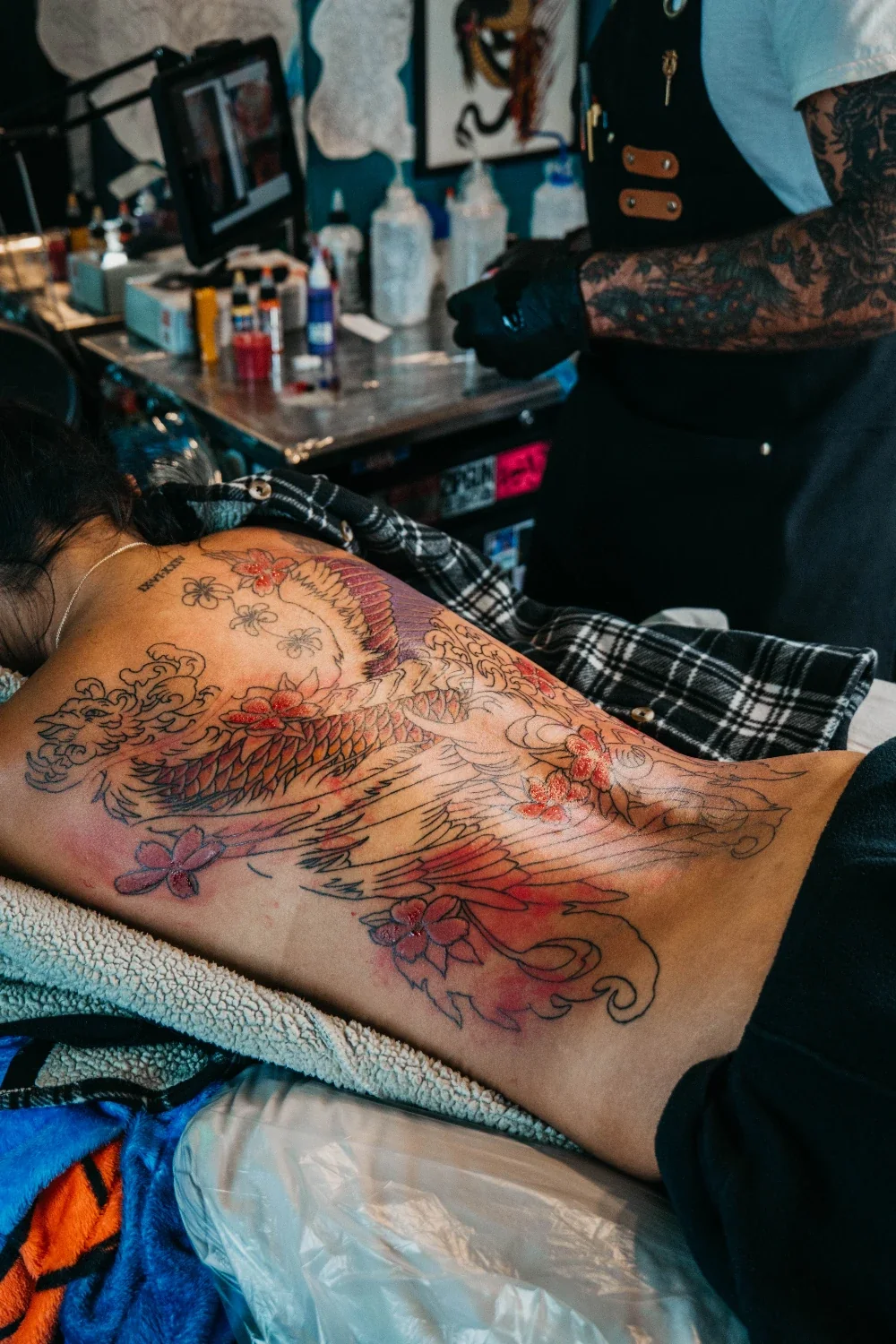 Back tattoo in progress — phoenix